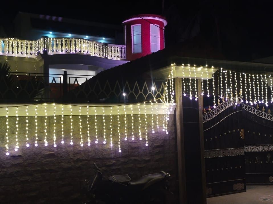 Night view of Villa Serenity Le Sejour Pondicherry decorated with lights.